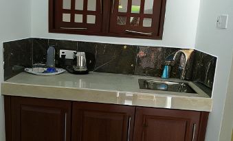 a kitchen counter with a sink and cabinets is shown in front of a window at Sea Breeze