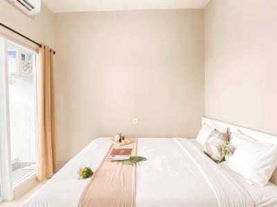 Cream Tone 1BR at Royal Sentul Park Apartment By Travelio