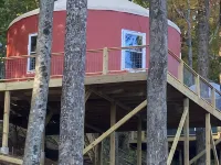 Elevated eclectic yurt with wrap-around porch, hot tub, and mountain view! Hotels in Piper Gap