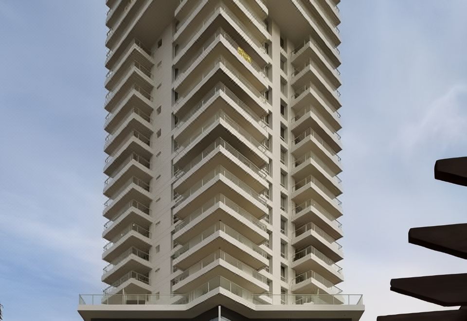 a tall , white building with a unique geometric pattern stands against a cloudy sky at David Tower Hotel Netanya by Prima Hotels - 16 Plus