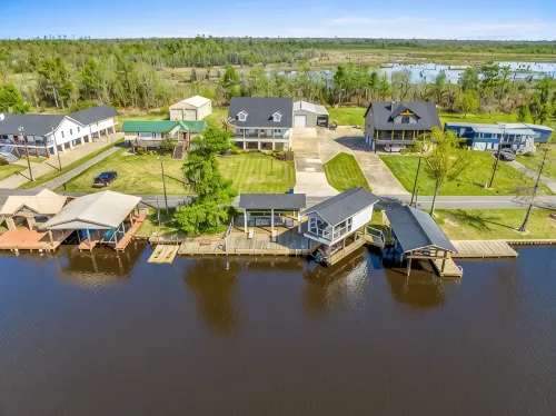 Luxury riverfront home w/ pool, fishing dock, & boat house w/ lift ! Sleeps 14