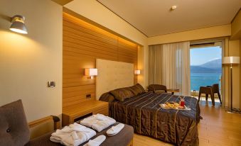 a modern hotel room with wooden walls , large windows offering ocean views , and a comfortable bed at Nafs Hotel