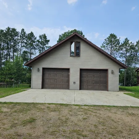 Three bedroom hide-a-way with spacious deck over looking Island Lake.