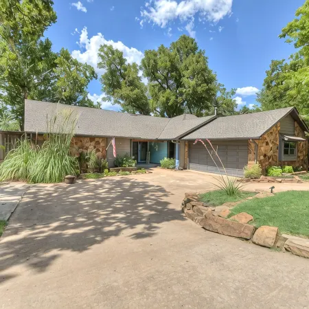 Quiet, spacious home with large deck in secluded Forest Oaks in central Edmond .