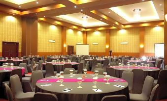 a large conference room with round tables and chairs arranged for a meeting or event at favehotel Rembang