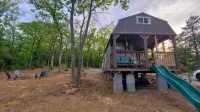 Cozy tiny cabin nested in the trees in a lake community, peaceful countryside.