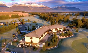 aerial view of a large resort surrounded by mountains , with a golf course visible in the distance at Hotel International