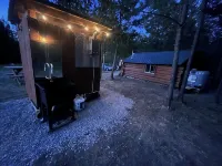 Retreat to our cozy cabin nestled in a private hideaway.Solar lights & shower