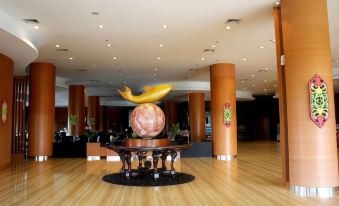 a large , modern hotel lobby with a round table in the center and multiple chairs surrounding it at Aquarius Boutique Hotel Sampit