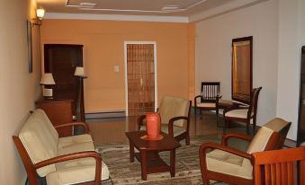 a spacious living room with various pieces of furniture , including couches , chairs , and a coffee table at Pomaria