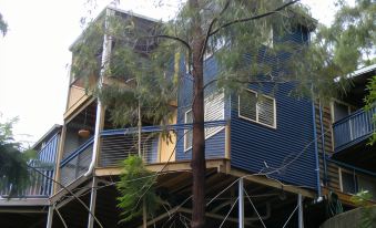 a modern building with blue and white exterior , surrounded by trees and other structures , under construction at Tambaridge Bed & Breakfast