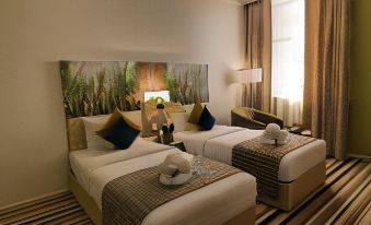 a hotel room with two beds , one on the left and one on the right side of the room at Royal View Hotel
