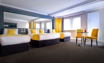 a hotel room with two beds , one on the left side and one on the right side of the room at Claregalway Hotel