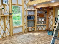 Elevated eclectic yurt with wrap-around porch, hot tub, and mountain view!