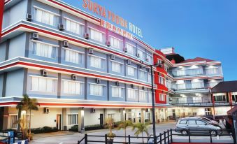 "a large building with a red and blue facade has the words "" suva kings hotel "" on it" at Surya Yudha Hotel