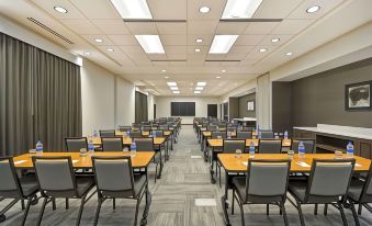 a large conference room with rows of chairs and tables , each table having a water bottle on it at Hyatt Place Fresno