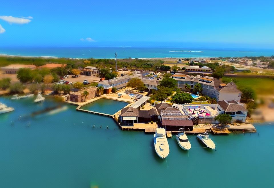aerial view of a marina with boats docked , surrounded by buildings and a body of water at Grand Hotel Excelsior Port Royal