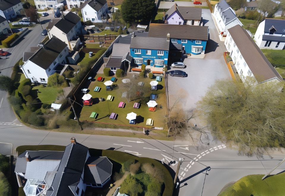 a bird 's eye view of a small town with houses , trees , and various outdoor dining areas at Parsonage Farm Inn