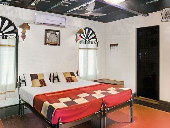 a modern bedroom with a large bed , a dart board on the wall , and an air conditioner at Emerald Isle