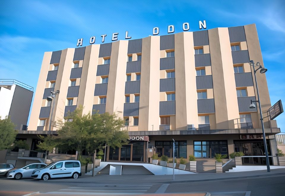 "a large hotel building with the name "" hotel doan "" on top , located on a street corner" at Hotel Odon
