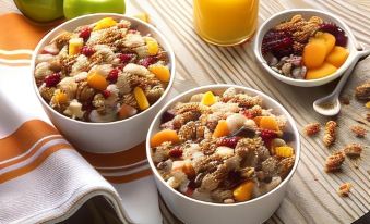 a dining table with a variety of bowls filled with various fruits , nuts , and other snacks at Home2 Suites by Hilton Hagerstown