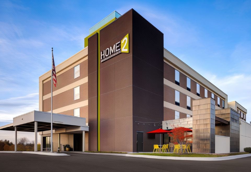 "a modern hotel with a large sign that reads "" home 2 "" prominently displayed on the side of the building" at Home2 Suites by Hilton Dekalb