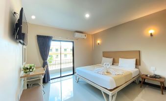 a modern hotel room with a large bed , white bedding , and a balcony door leading to a balcony at MaiHom Villa