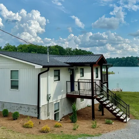 BRAND NEW Lake Front home. Private cove and boat dock! Modern farmhouse appeal!