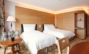 a hotel room with two beds , one on the left and one on the right side of the room at Sun Valley Hotel