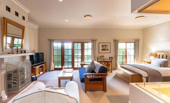 a spacious living room with wooden furniture , including a couch , chairs , and a dining table at Strathearn Park Lodge