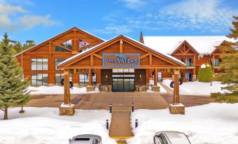 "a large wooden building with a sign that says "" skywater "" is surrounded by snow and cars" at The Waters of Minocqua