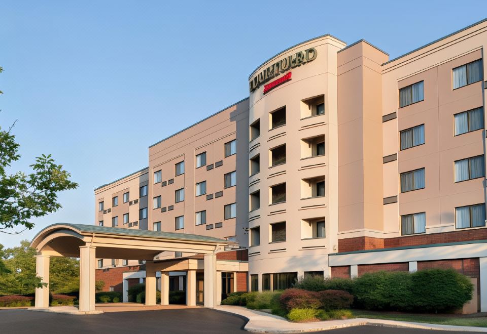 "a large hotel with a red roof and the words "" courtyard by marriott "" on top" at Courtyard Middletown Goshen