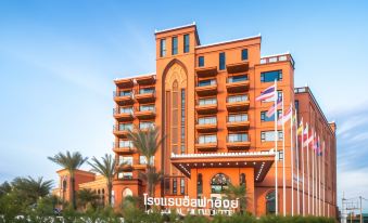 "a large orange building with a sign that reads "" sunvalley resort "" in front of it" at Alfahad Hotel