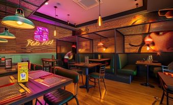 a modern restaurant interior with wooden tables , booths , and chairs , as well as neon signs on the walls at Ibis London Greenwich