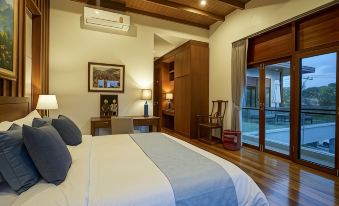 a modern bedroom with wooden floors , white walls , and a large window that offers views of the outdoors at Mae Rim Grace