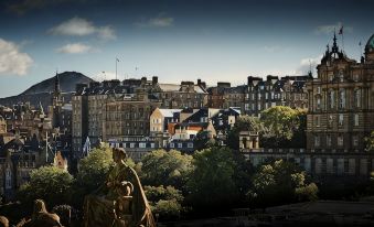 a cityscape with a statue of a woman in the foreground and tall buildings in the background at Old Town Chambers, Autograph Collection