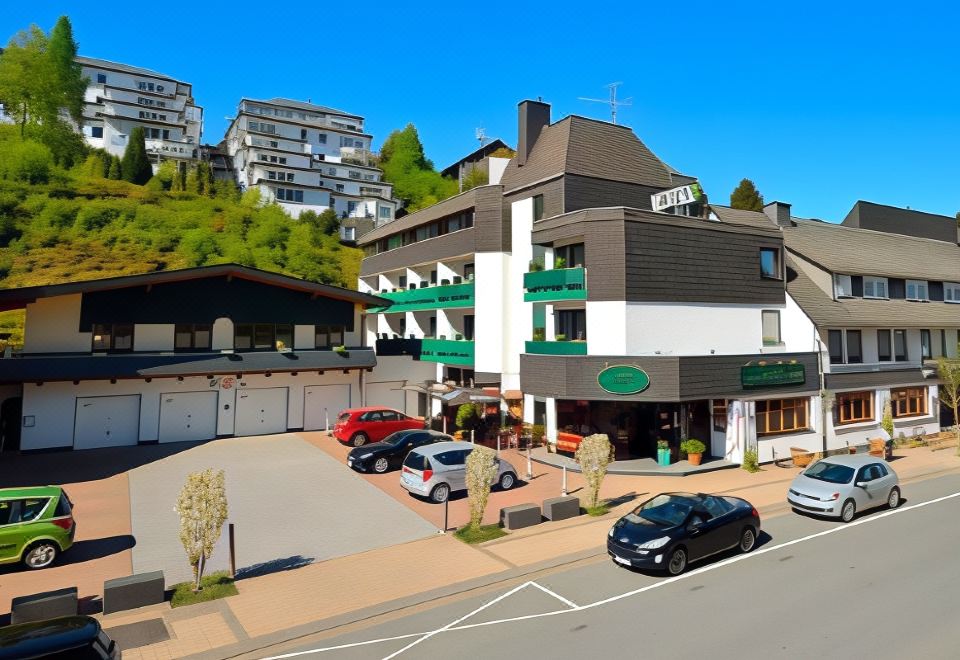 a street view of a building with cars parked in front and buildings behind it at Hotel Central