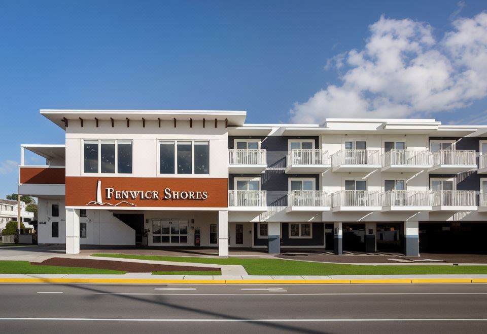 "a white building with a brown sign that says "" fenwick shores "" on the side , located near a street" at Fenwick Shores, Tapestry Collection by Hilton