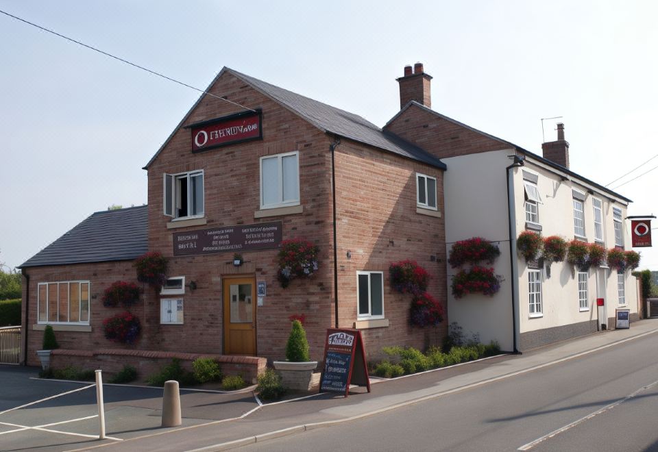 "a brick building with a sign that says "" the raj tree "" in front of it" at The Sun Inn