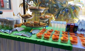 a buffet table filled with a variety of food items , including bowls of soup and fruits at Hotel la Mansión