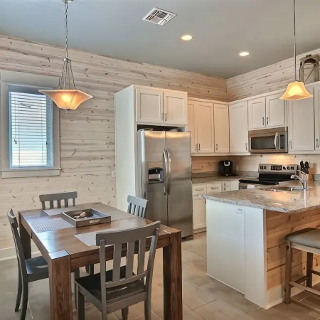 In-town coastal getaway, with a heated pool & level 2 Tesla EV charger on site.