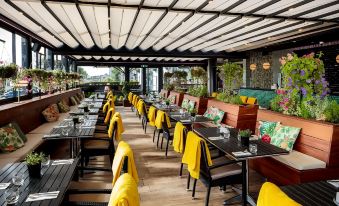 a large , well - lit outdoor dining area with multiple tables and chairs arranged for guests to enjoy a meal at Claregalway Hotel