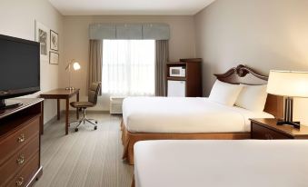 a hotel room with two beds , a desk , and a chair , all neatly arranged in a well - lit area at Country Inn & Suites by Radisson, Salisbury, MD