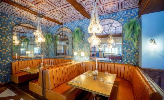 a restaurant with wooden booths and tables , a blue and green ceiling , and hanging light fixtures at Grosvenor Pulford Hotel & Spa