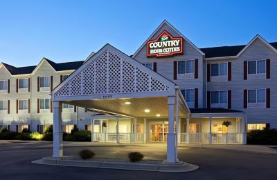 a country inn & suites hotel with its large entrance and a sign above it at Country Inn & Suites by Radisson, Watertown, SD
