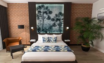 a modern bedroom with a white bed , blue and white bedding , and a brick wall decorated with a mural of flowers at Litchfield Outback Resort