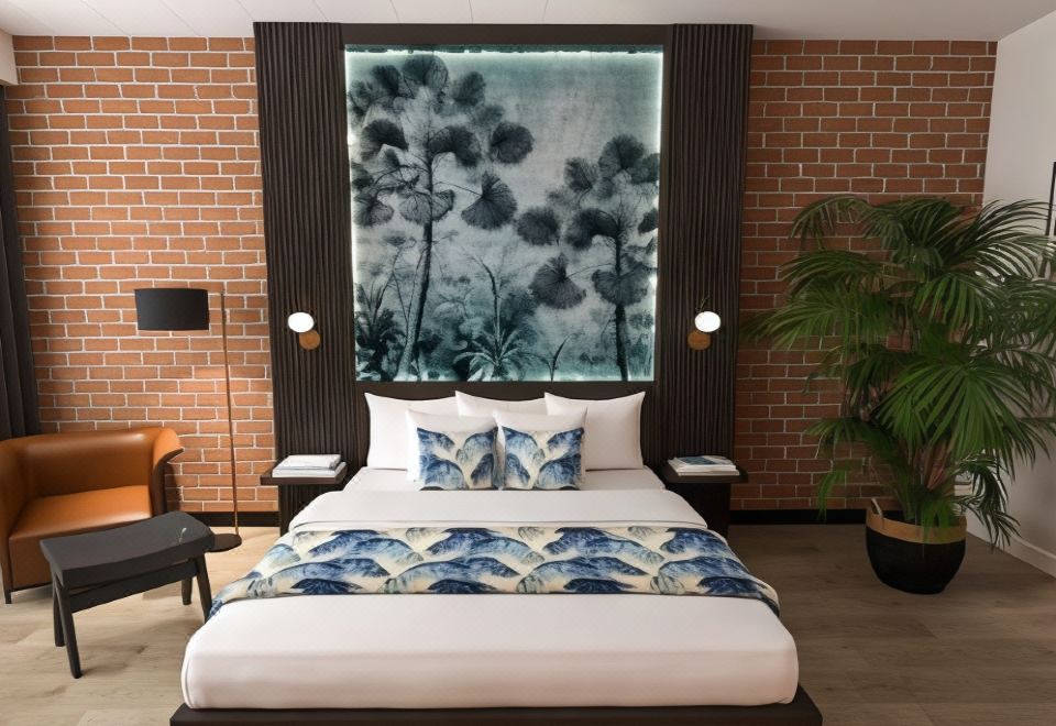 a modern bedroom with a white bed , blue and white bedding , and a brick wall decorated with a mural of flowers at Litchfield Outback Resort
