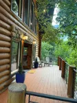 Cozy log cabin secluded in a mountain forest with hot tub, sauna, private patio.