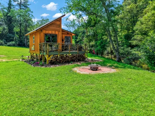 Tiny cabin sits by a bubbling, stocked creek. Pet friendly for a fee, hot tub
