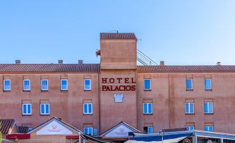"a building with a sign that says "" hotel palacios "" is shown with a clear blue sky in the background" at Hotel Palacios
